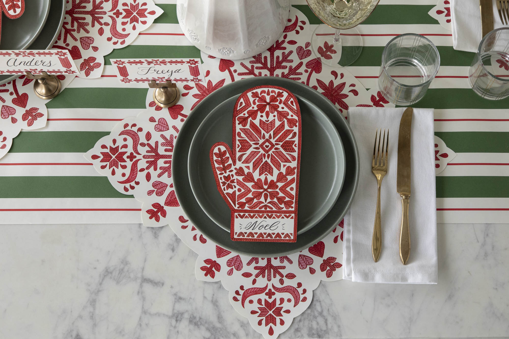 An elegant table setting featuring the Die-cut Fair Isle Snowflake Placemat, Fair Isle Mitten Table Accent and Green & Red Awning Stripe Runner.