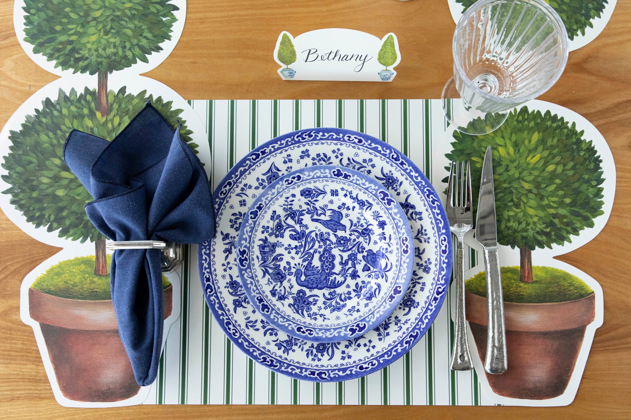 A spring place setting for one with the Die-cut Green French Frame Placemat and Rattan Runner underneath.