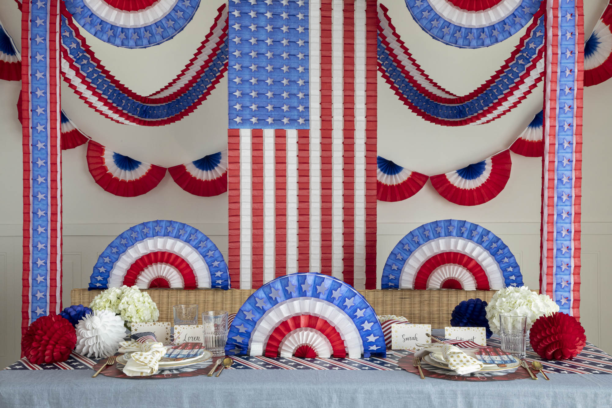 Patriotic themed table setting with Patriotic Honeycomb Paper adorning the tables and walls.