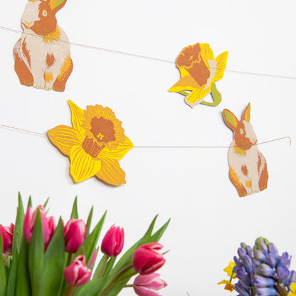 Rabbits Garland by East End Press hanging on a wall. 