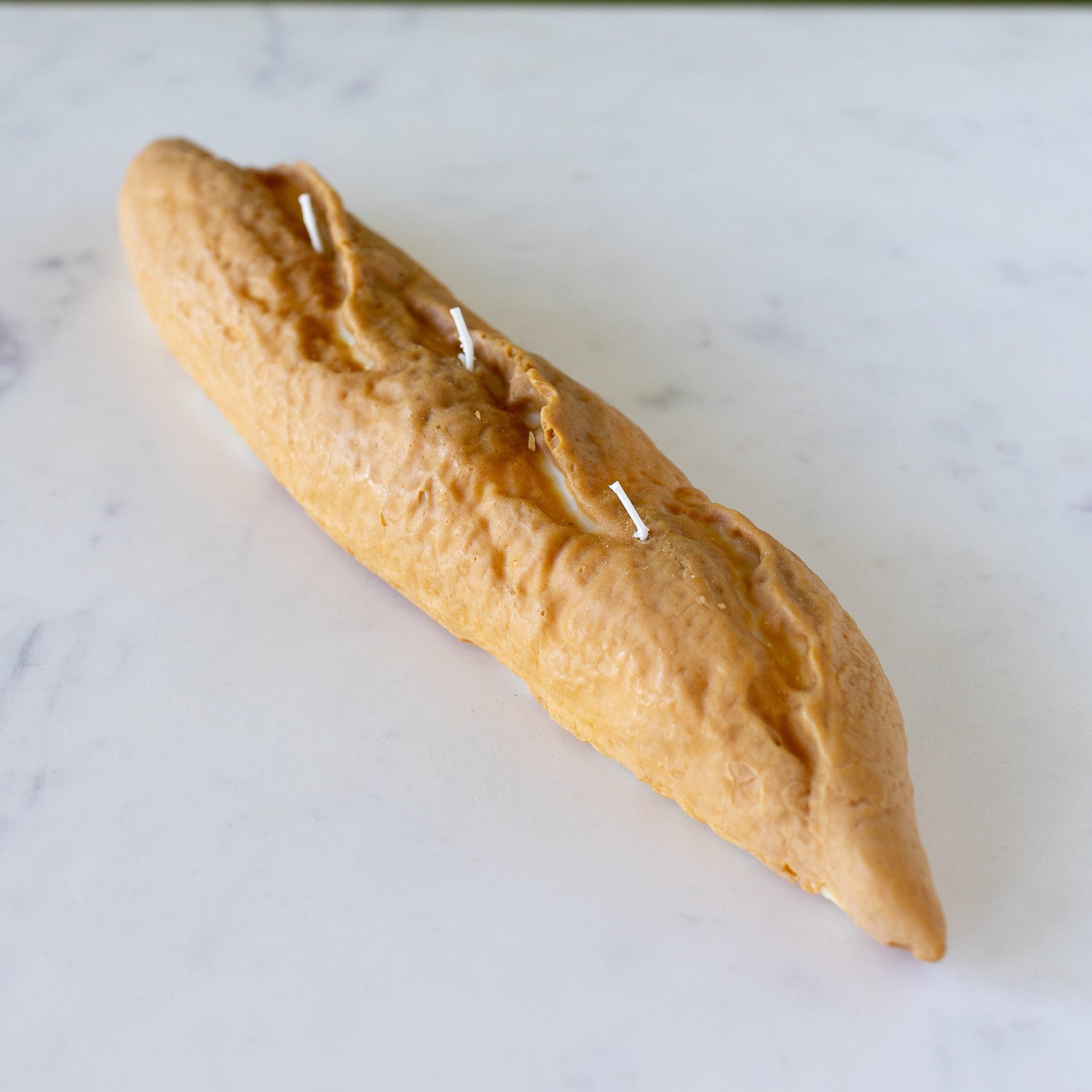 Baguette Candle on a table.