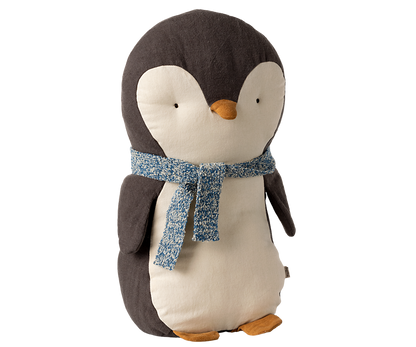 A stuffed animal penguin with a blue scarf tied around his neck.