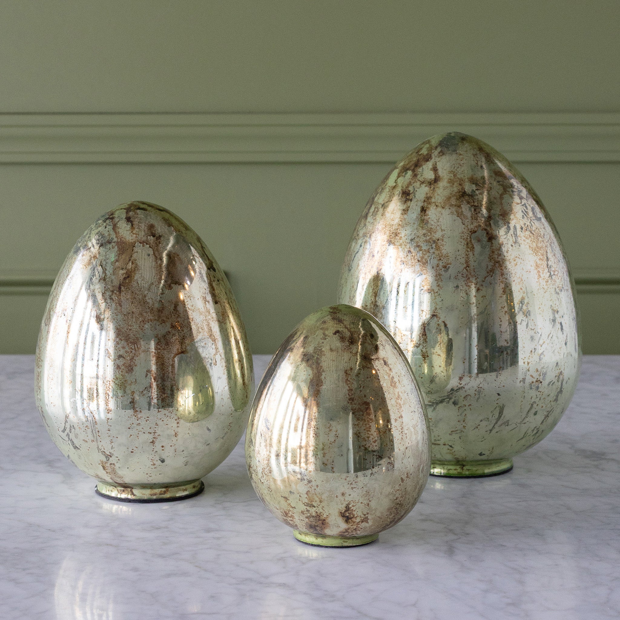 Mercury Glass Easter Eggs in three sizes on a table.