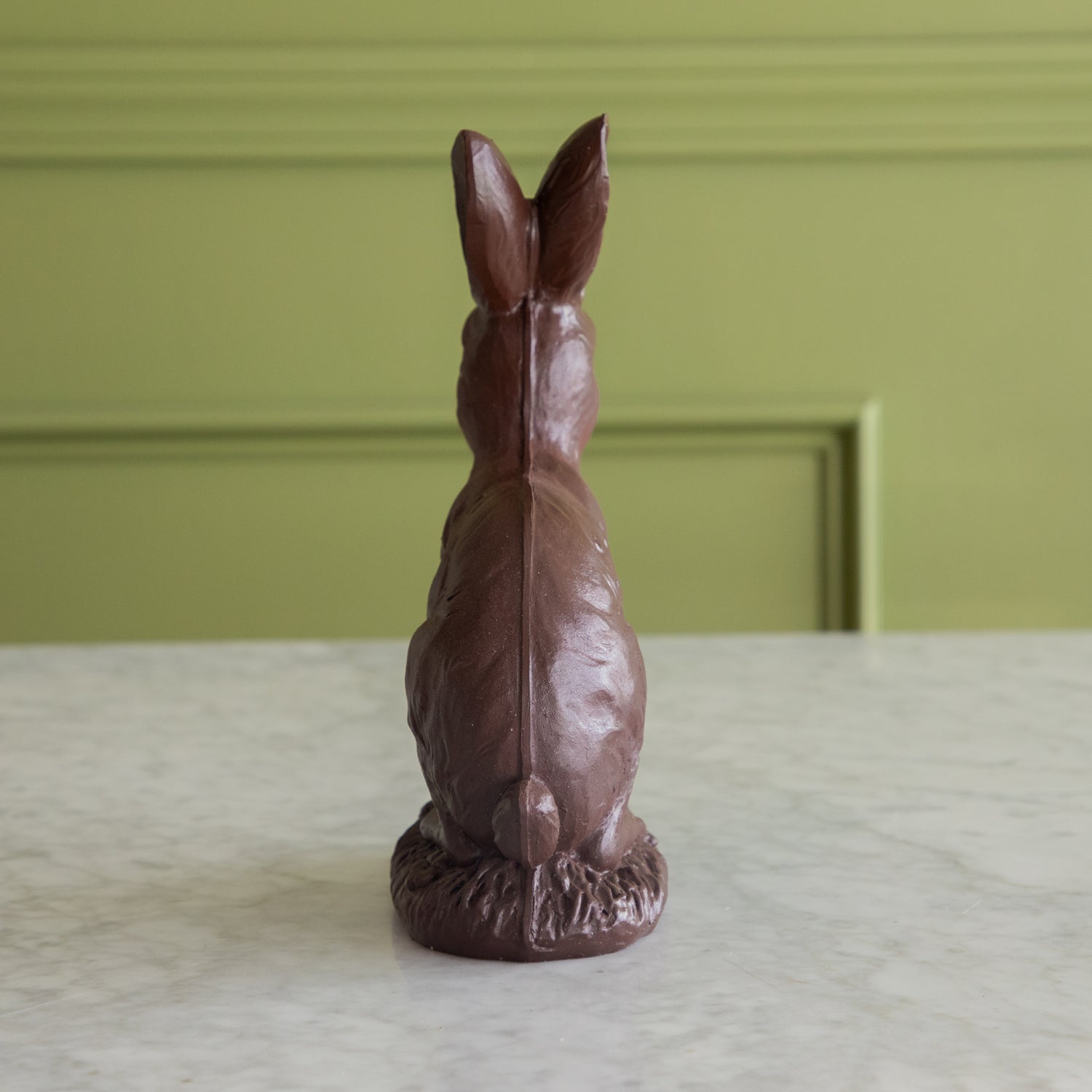 The back side of the &quot;Chocolate&quot; Sitting Bunny showing its tail.