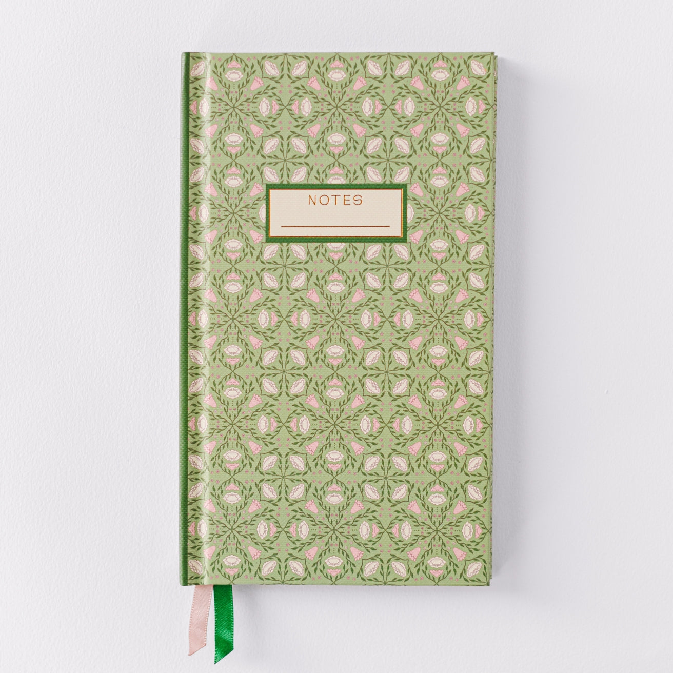 front of the green notebook