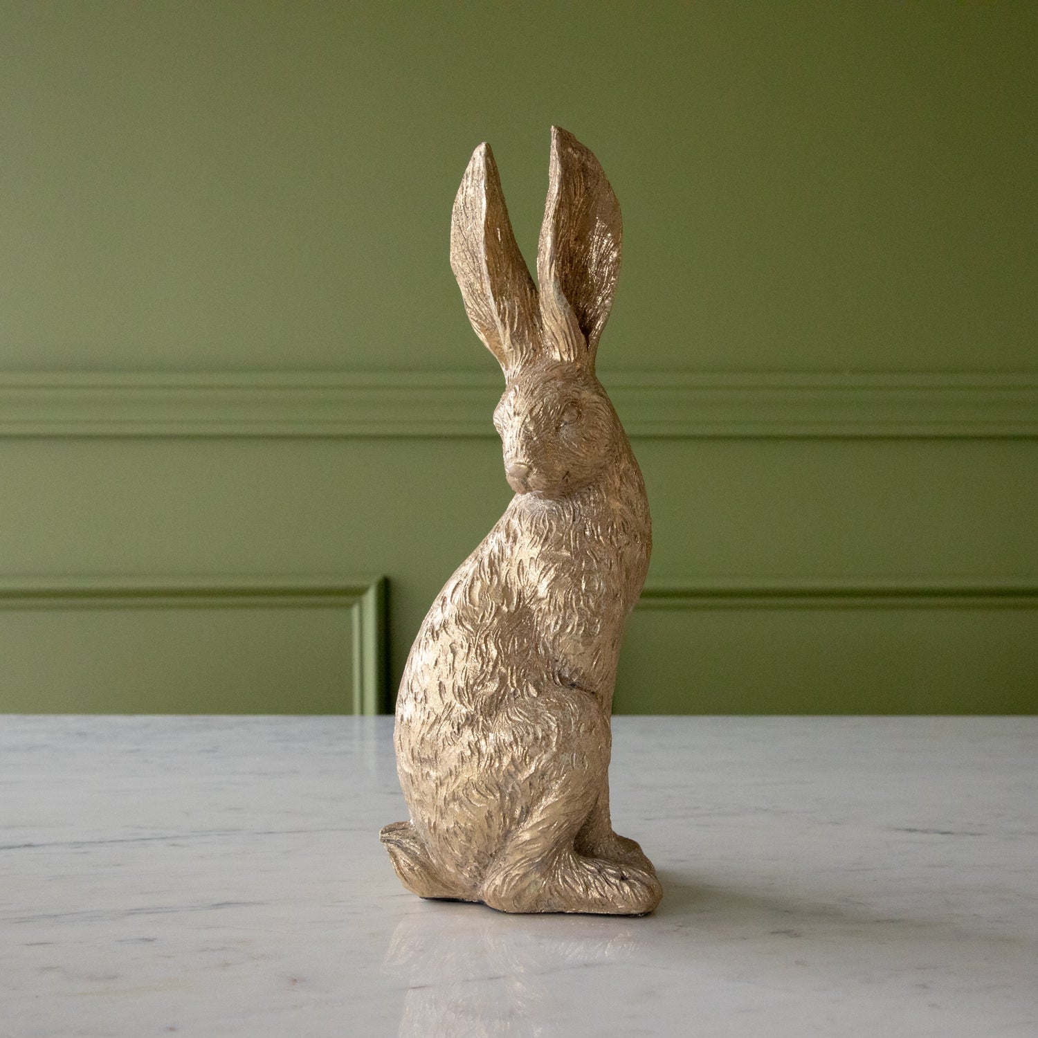 Head Down Gold Leaf Rabbit in a sitting position.