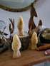 Three morel mushroom candles styled on a table