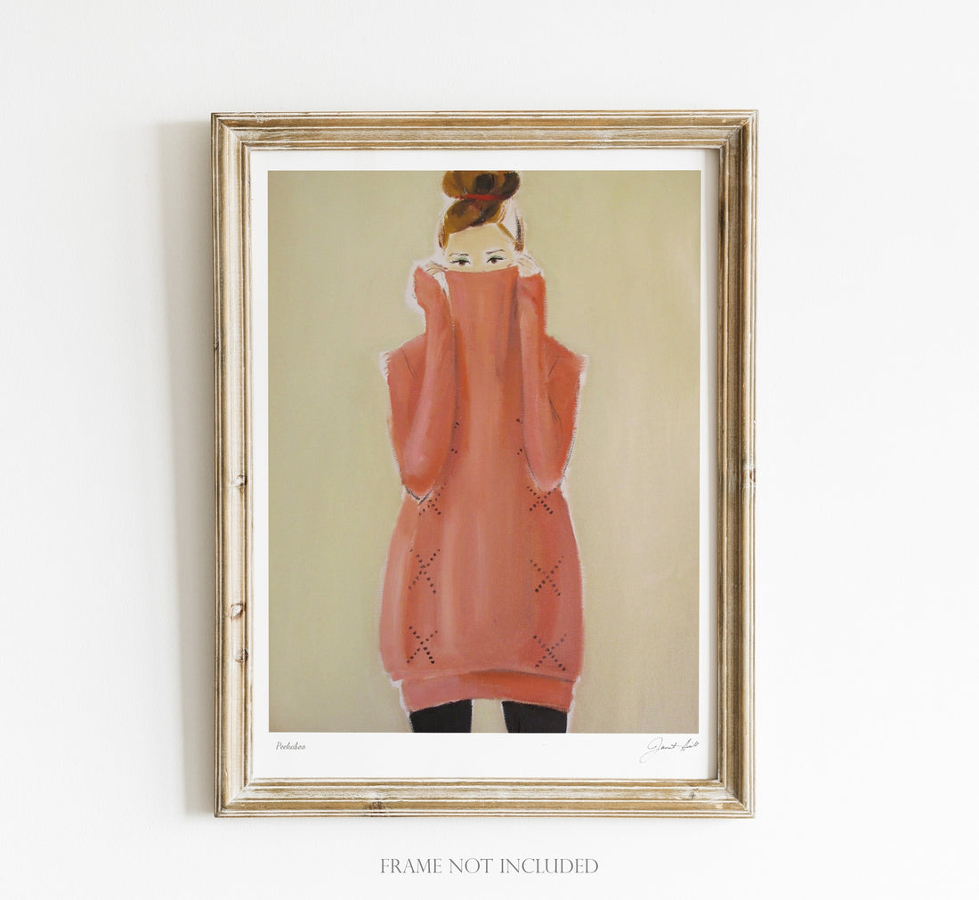 A framed painting of a stylish woman in a pink turtleneck with her hair up, portrayed on fine art paper using Epson Ultrachrome inks, displayed on a wall. Note: Peekaboo Small Art Print by Janet Hill.