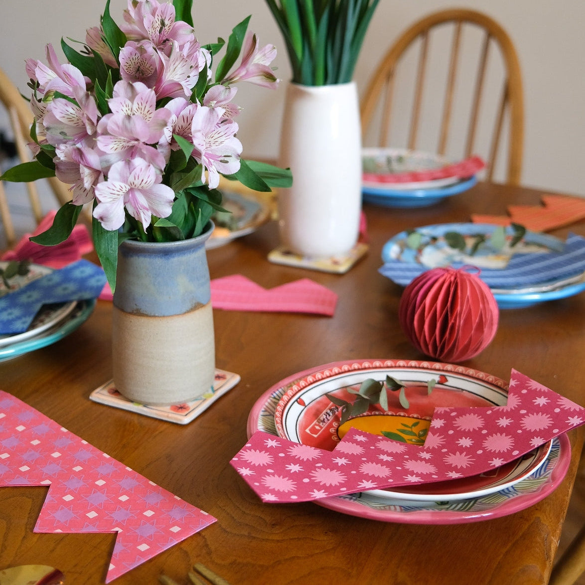 East End Press Pink Paper Party Crown on a plate.