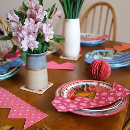 East End Press Pink Paper Party Crown on a plate.