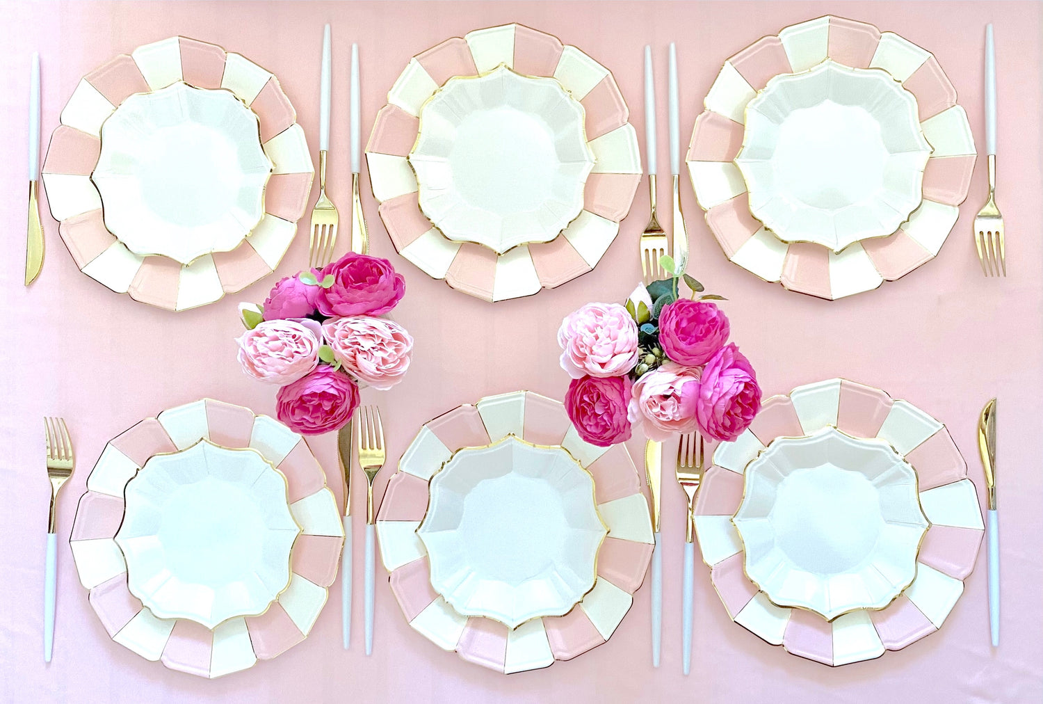 Table set with Pink Candy Dinner Plates with flowers on the table.  