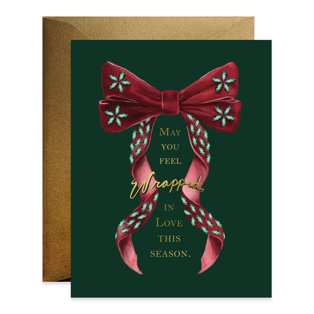 Front of green greeting card stating &quot;May you feel wrapped in love this season&quot; with an illustration of an oversized red bow on it.