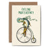 An illustrated blank Cycling Profishiency Card from Hester & Cook stationery, a UK based company, featuring a whimsical depiction of a fish riding an old-fashioned penny-farthing bicycle with the caption "Cycling Profishiency". 