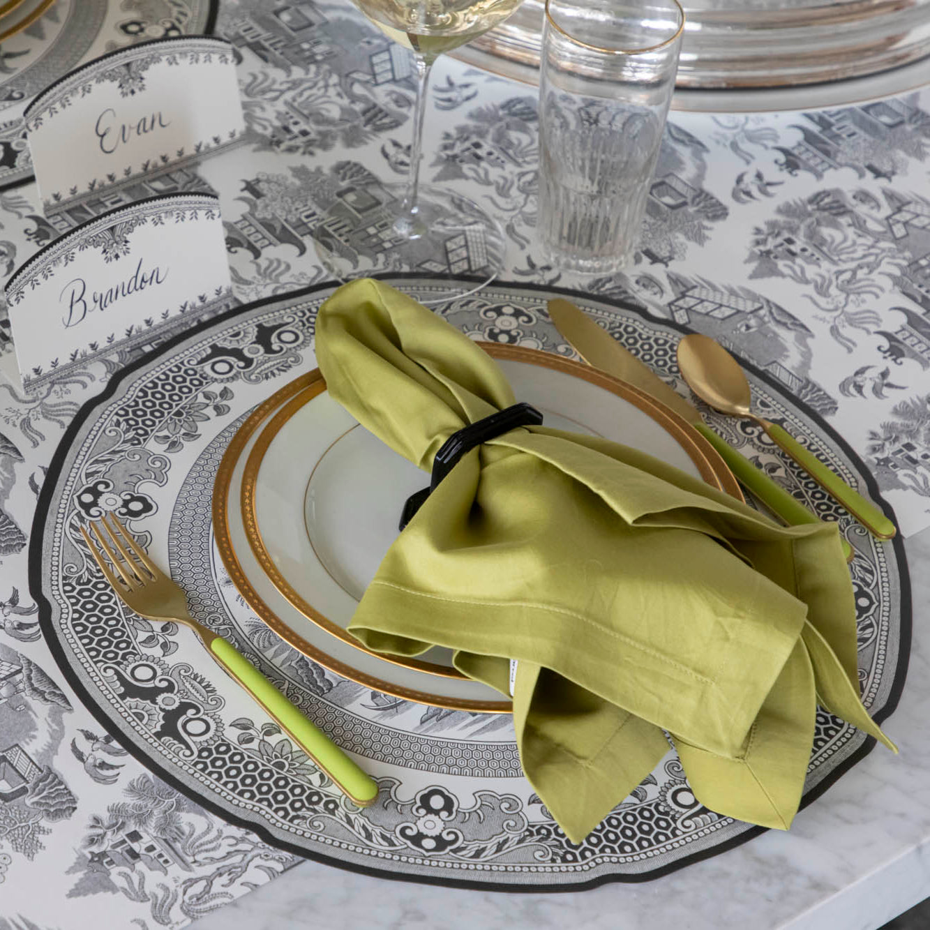 Die-cut Blue Willow Placemat on the Black Willow Runner and a classic place setting on top.