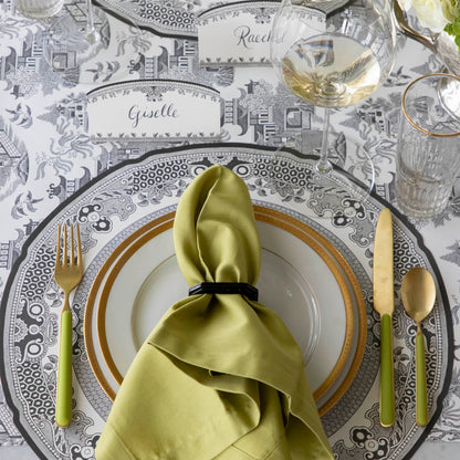 Die-cut Blue Willow Placemat on the Black Willow Runner and an elegant place setting on top.