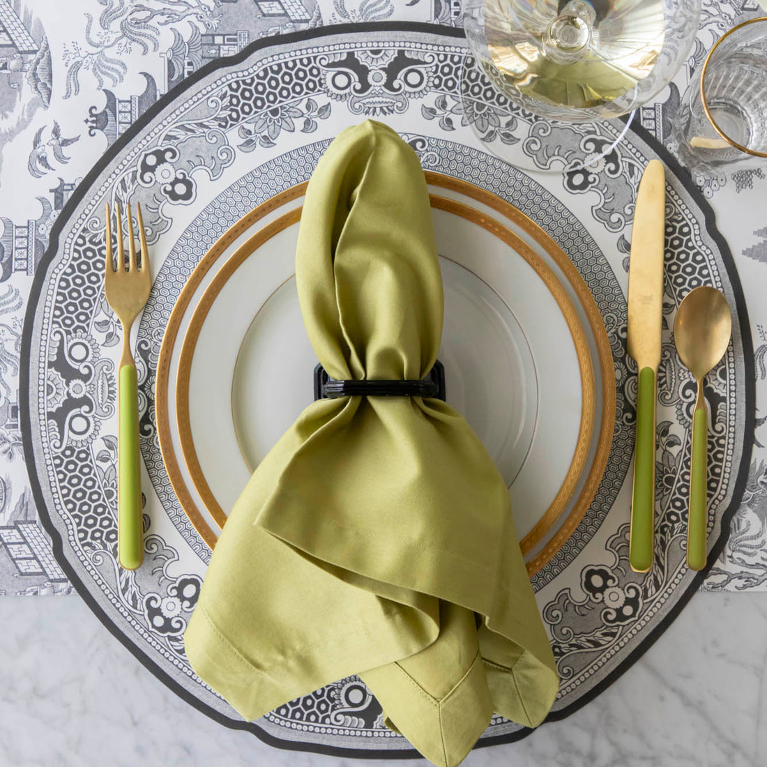 Die-cut Blue Willow Placemat on the Black Willow Runner and an elegant place setting on top.