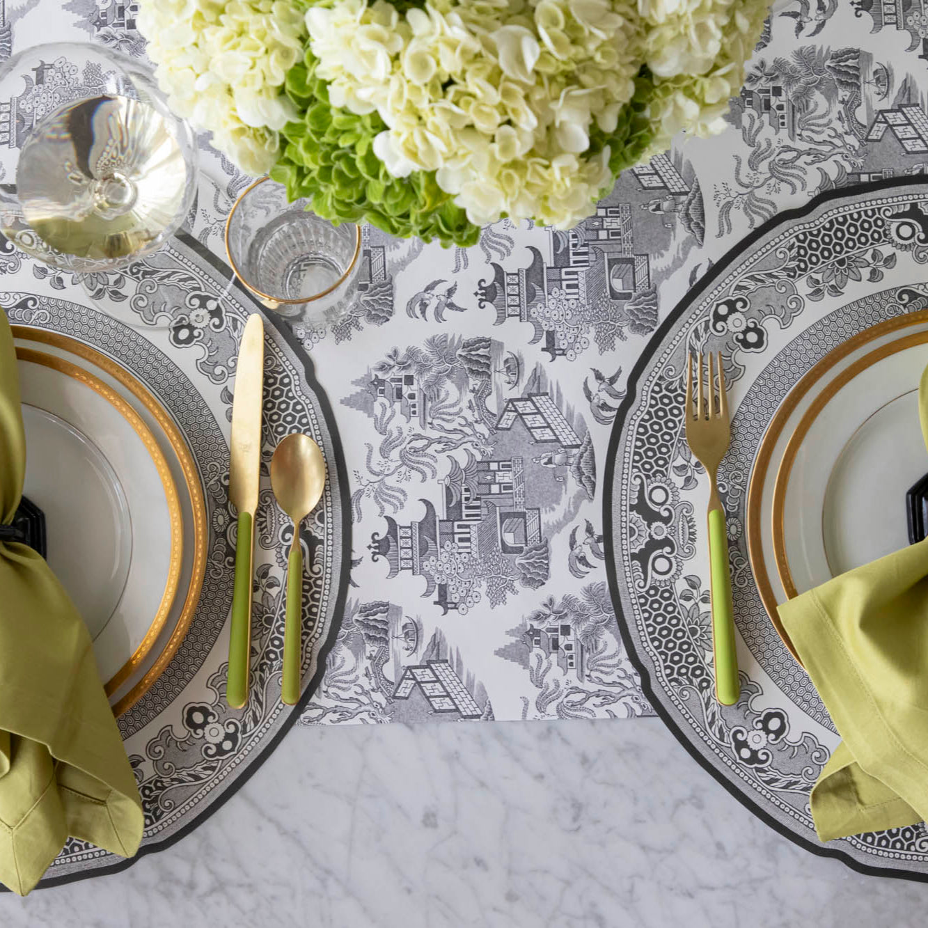 Black Willow Runner under the Die-cut Black Willow Placemat with an elegant place setting on top.