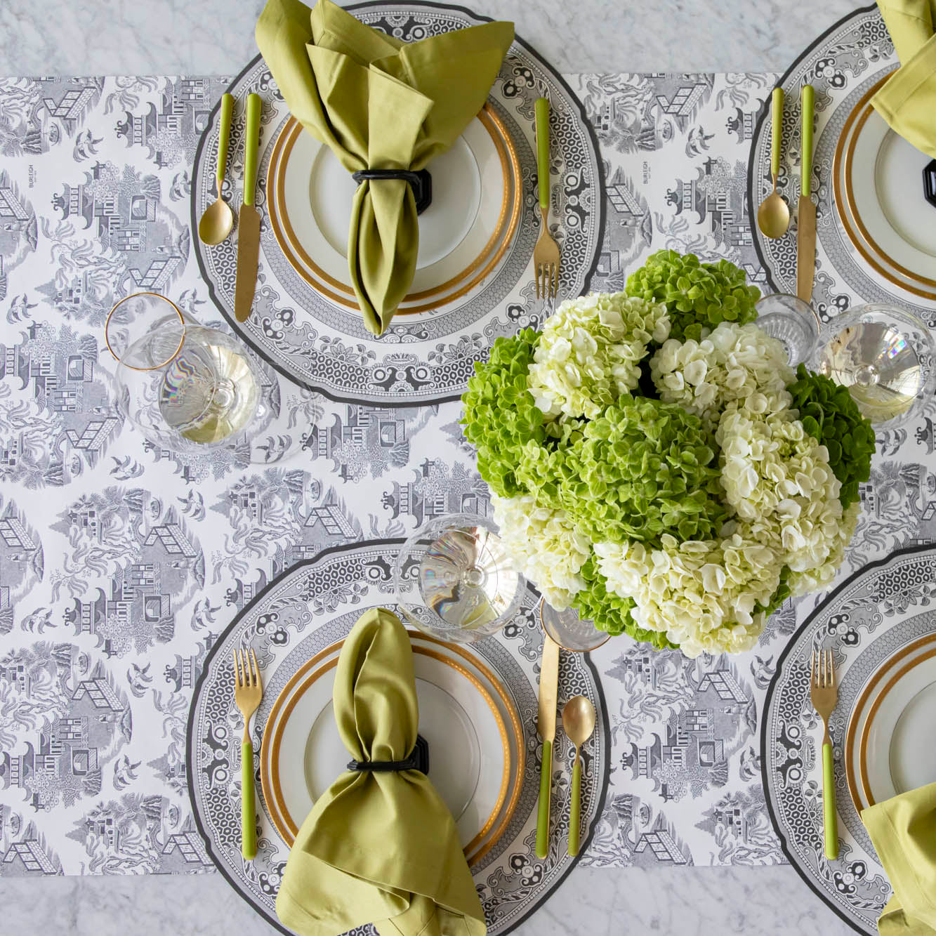 Black Willow Runner under the Die-cut Black Willow Placemat with an elegant place setting on top.