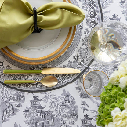 Black Willow Runner under the Die-cut Black Willow Placemat with an elegant place setting on top.