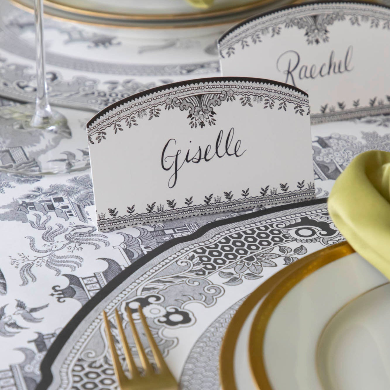 Black Willow Place Card with &quot;Giselle&quot; written on it, behind a place setting.