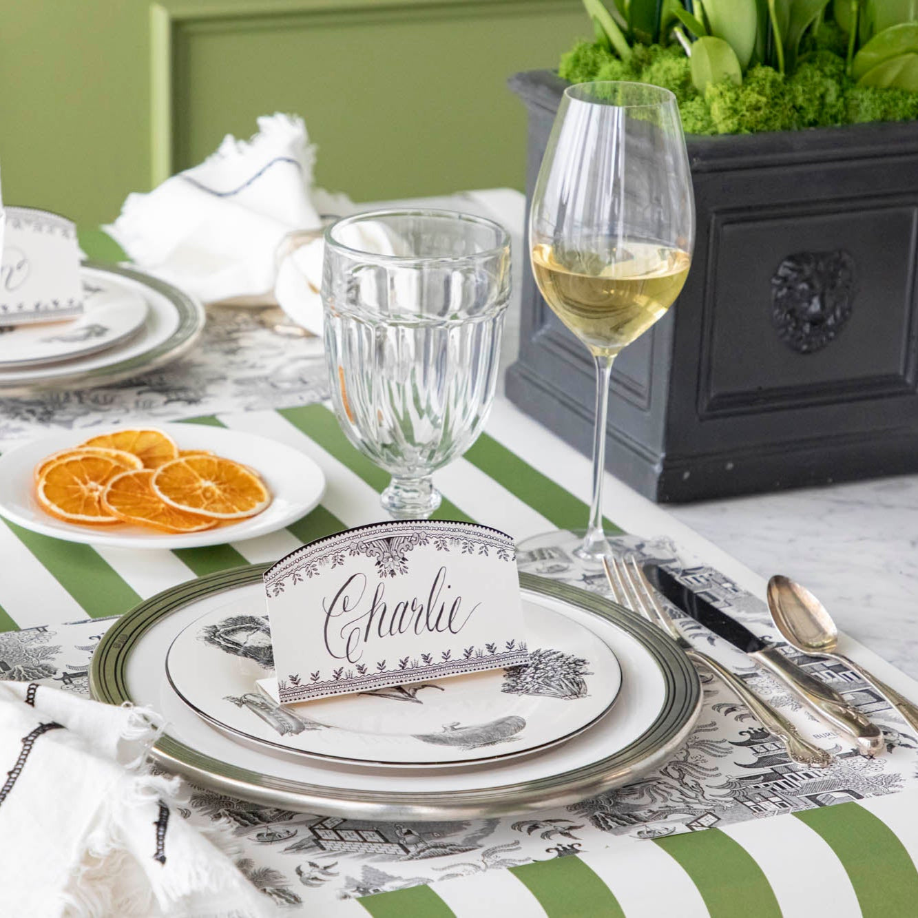 Black Willow Placemat on the Classic Moss Green Stripe Runner and dinnerware on top.