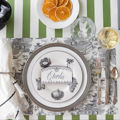 Black Willow Placemat on the Classic Moss Green Stripe Runner, and dinnerware on top.