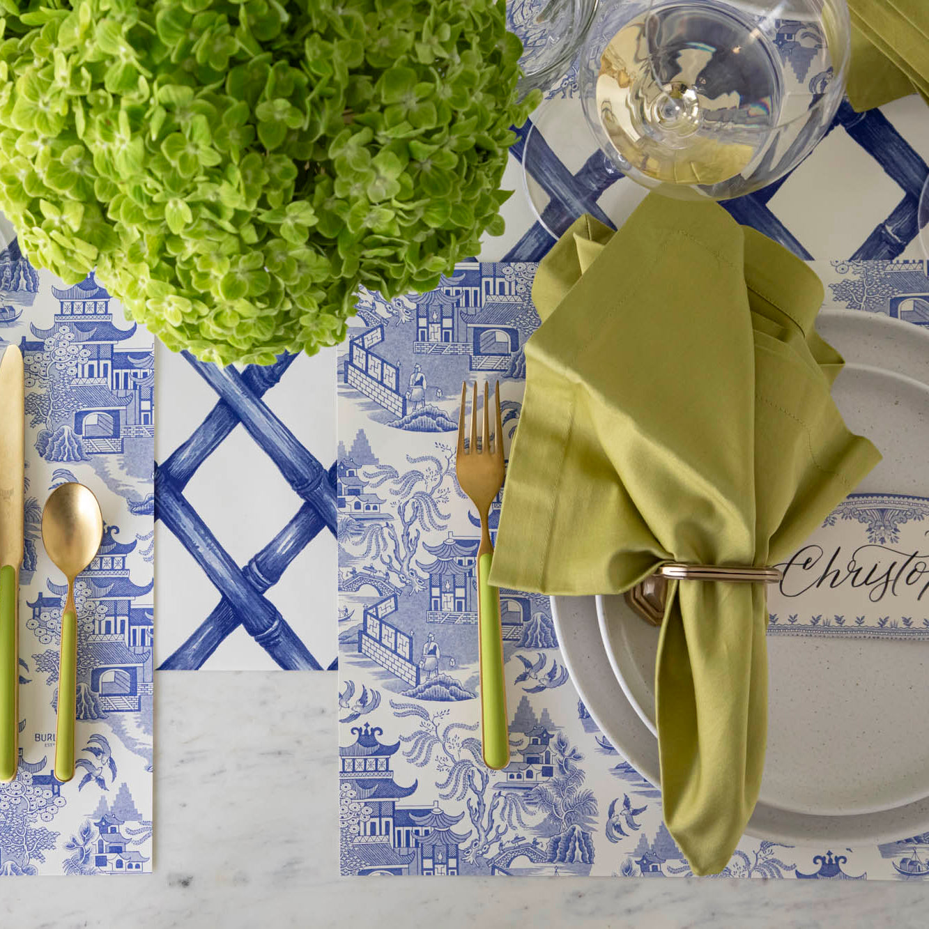 Blue Willow Classic Placemat with the Blue Lattice Runner underneath, styled elegantly with a place setting for one featuring colors of green and gold.