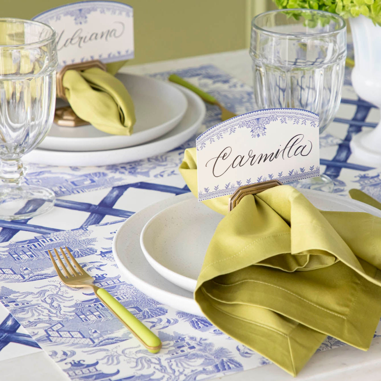 Blue Willow Classic Placemat with the Blue Lattice Runner underneath, styled elegantly with a place setting for two featuring colors of green and gold.