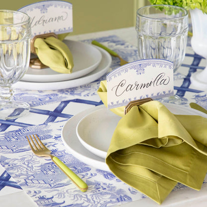 Blue Willow Classic Placemat with the Blue Lattice Runner underneath, styled elegantly with a place setting for two featuring colors of green and gold.