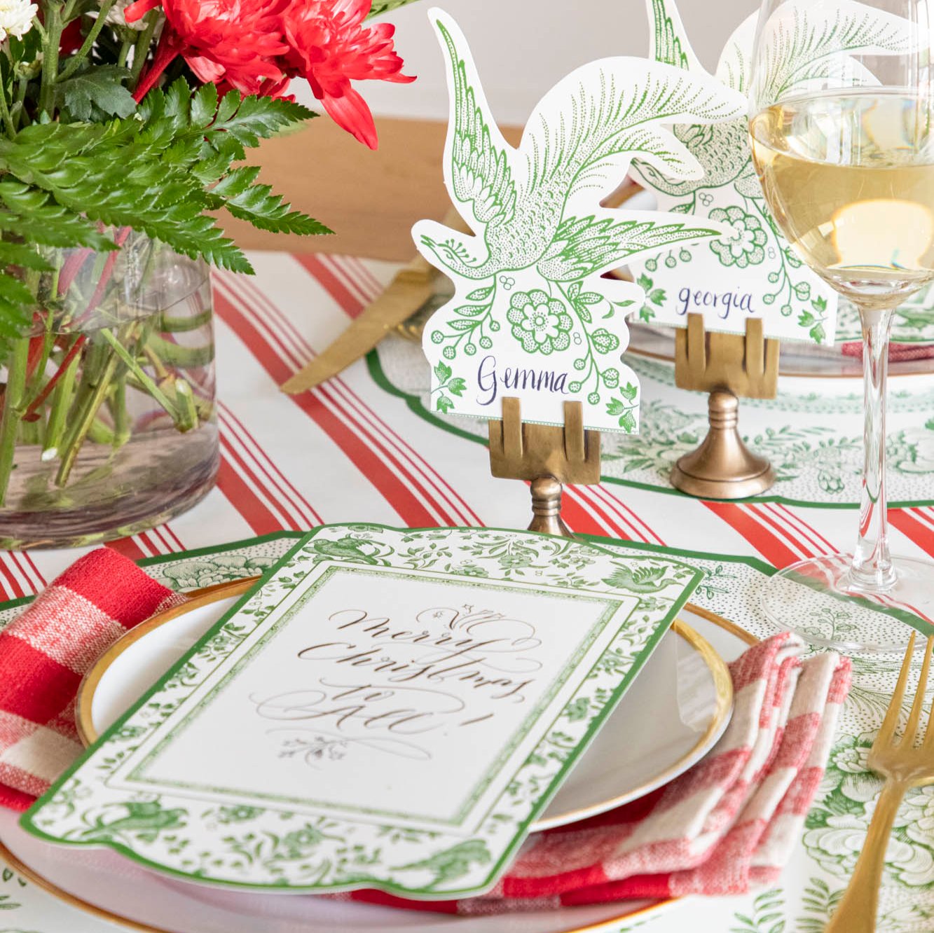 An elegant table setting featuring the Green Asiatic Pheasants Place Card with &quot;Gemma&quot; written on it, paired with the Green Regal Peacock Placemat and  table card.