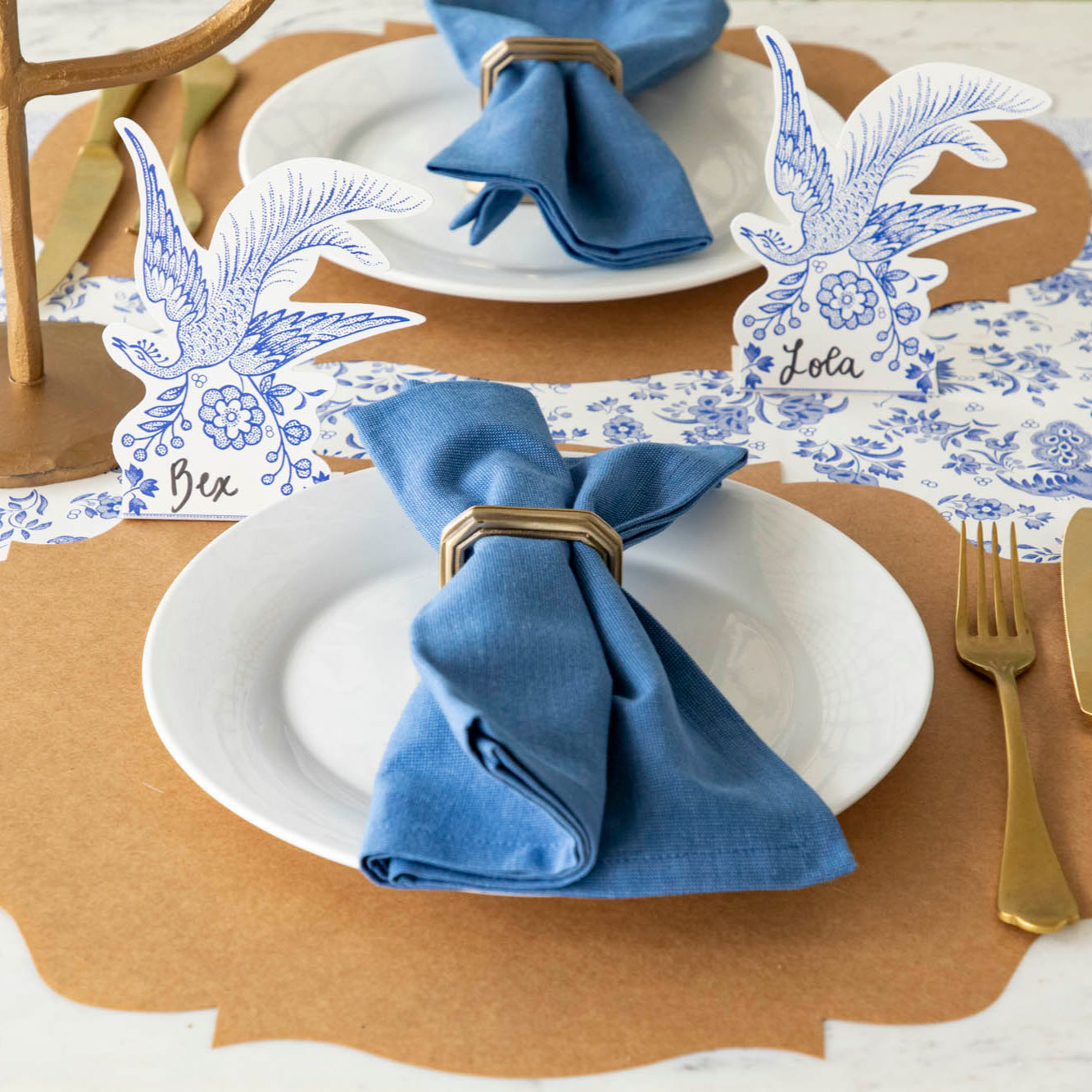 Blue Asiatic Pheasants Place Card behind an elegant place setting.