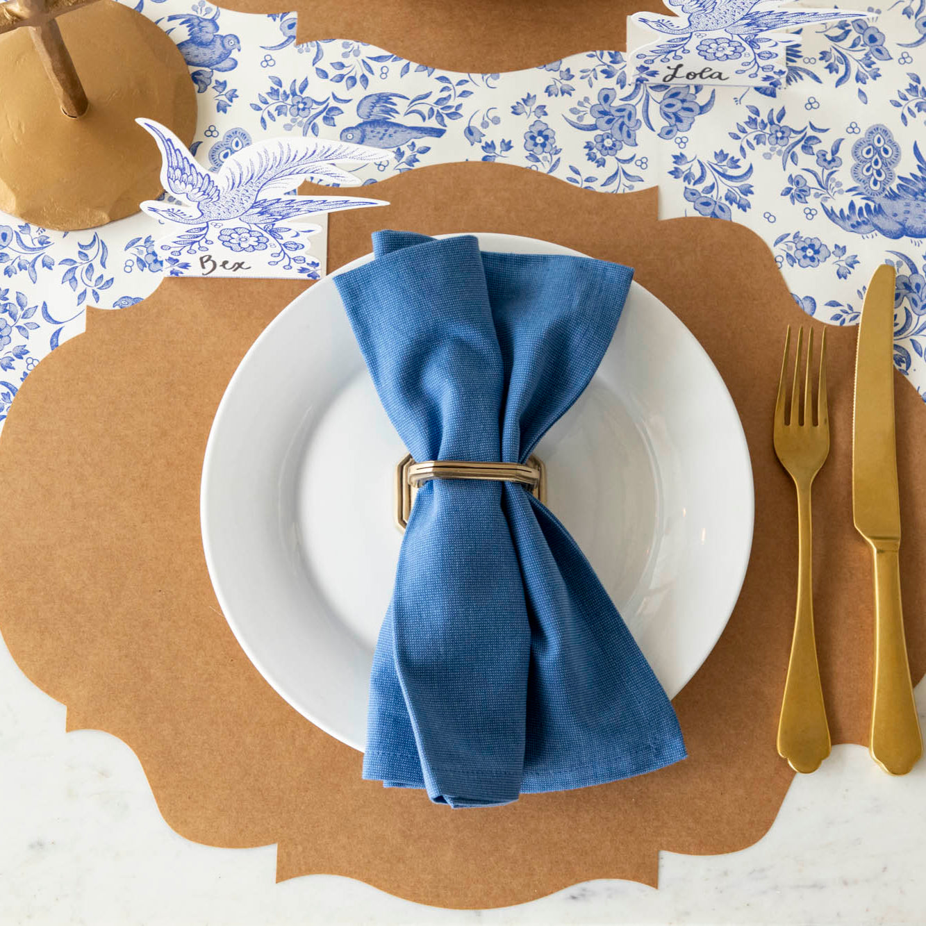 Blue Regal Peacock Runner under the Kraft French Frame Placemat with a place setting. 