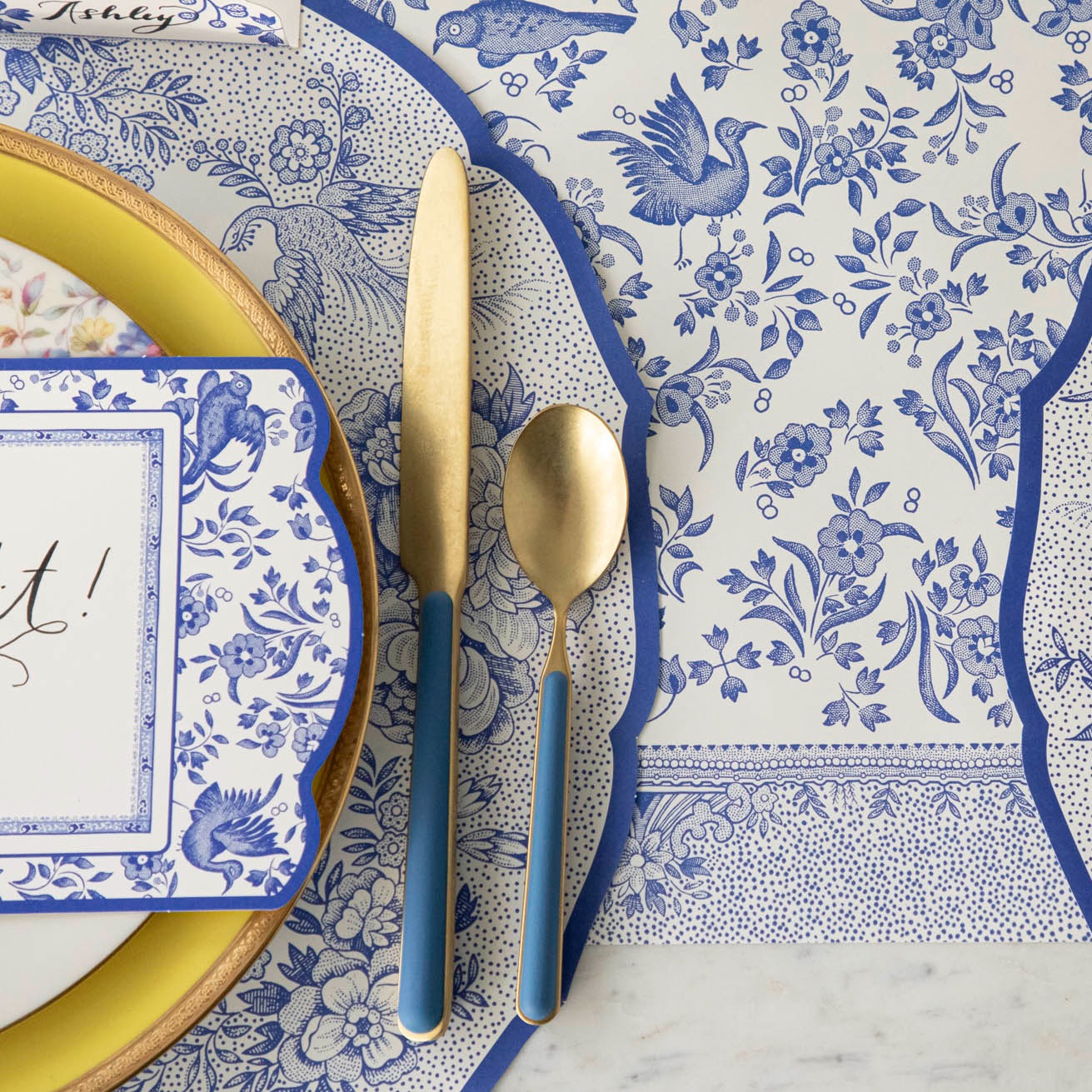 Close-up of the Die-cut Blue Asiatic Pheasants Placemat in an elegant place setting, showing the artwork in detail.