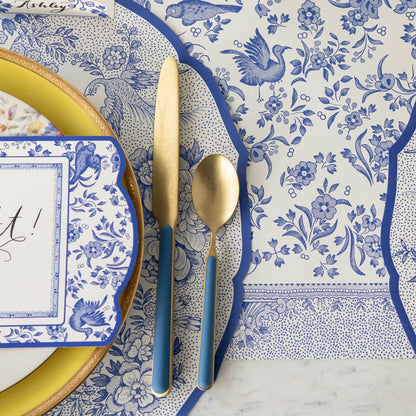 Close-up of the Die-cut Blue Asiatic Pheasants Placemat in an elegant place setting, showing the artwork in detail.