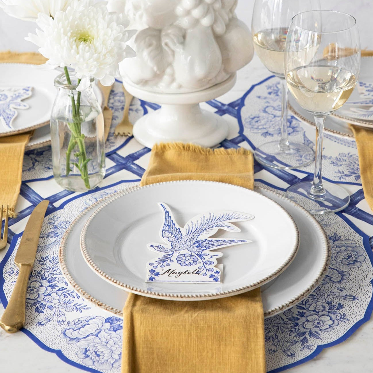 The Die-cut Blue Asiatic Pheasants Placemat in an elegant table setting.