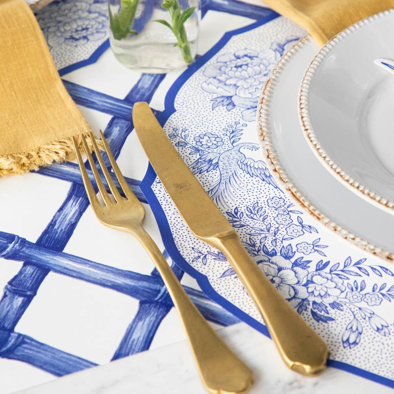 Close-up of the Die-cut Blue Asiatic Pheasants Placemat in an elegant place setting, showing the artwork in detail.