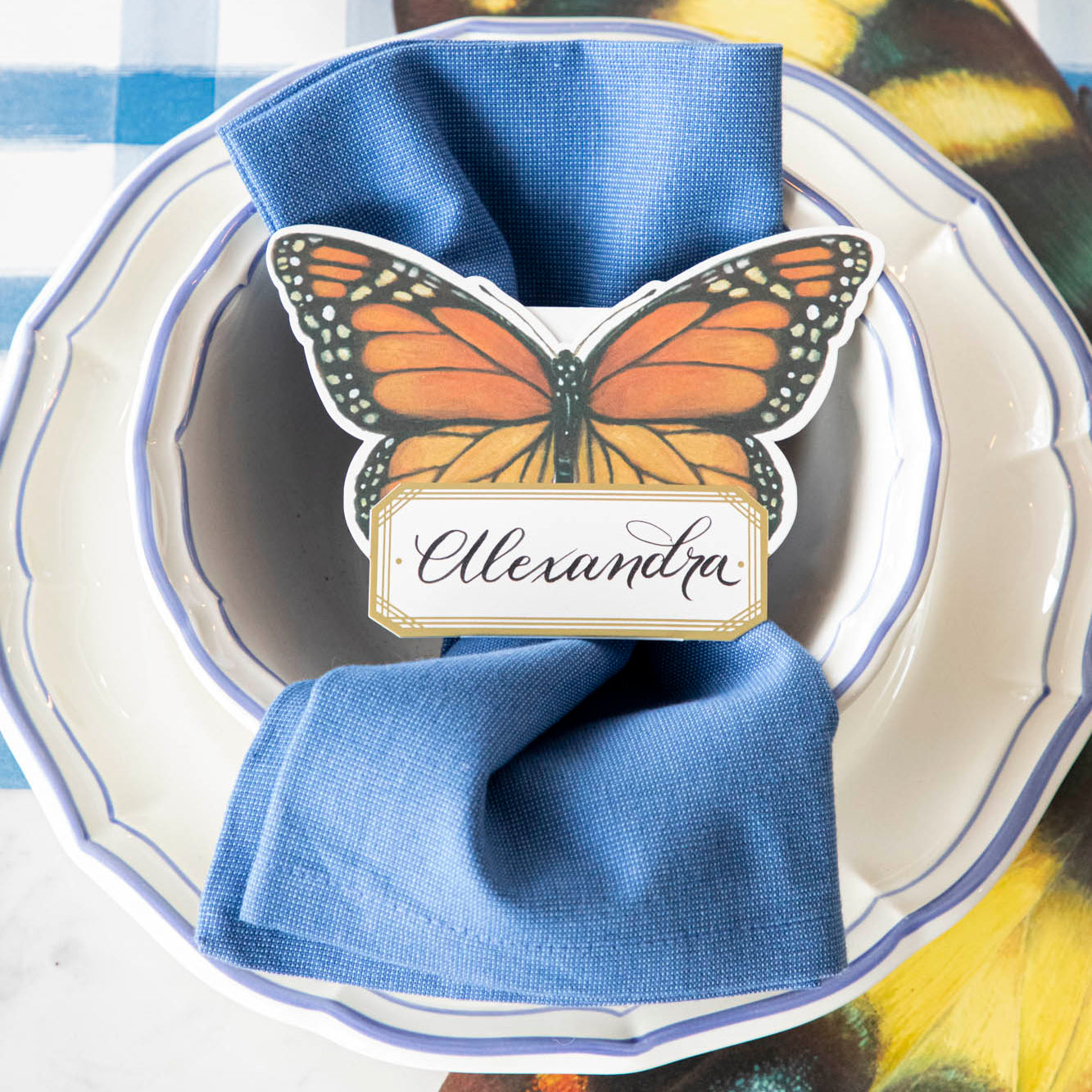 Monarch Butterfly Place Card with &quot;Alexandra&quot; written on it, on a butterfly themed place setting.