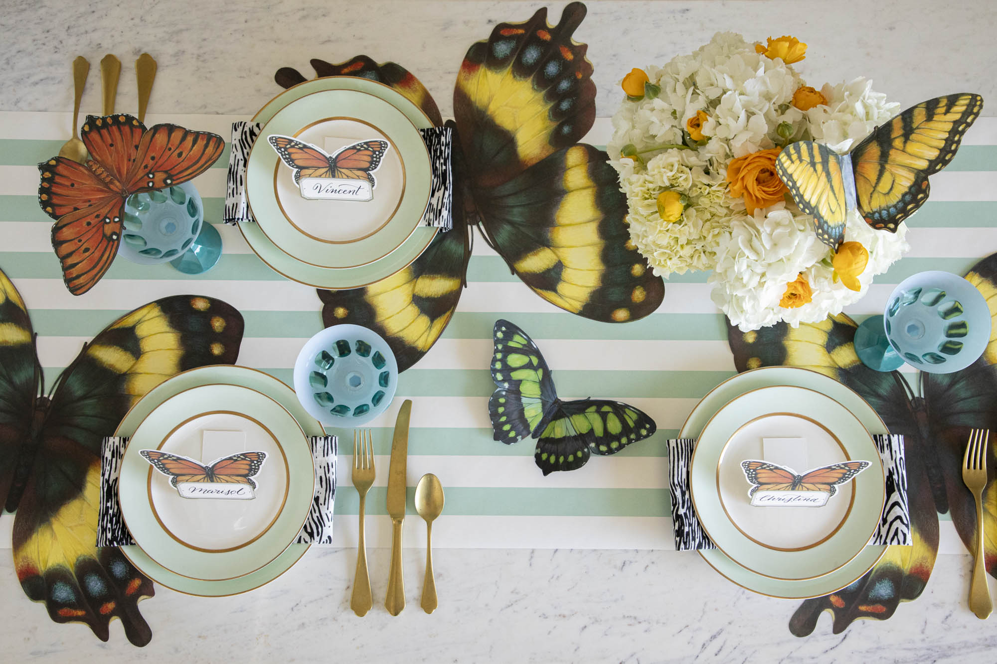 Overhead view of an elegant butterfly-themed tablescape featuring Die-cut Butterfly Placemats.