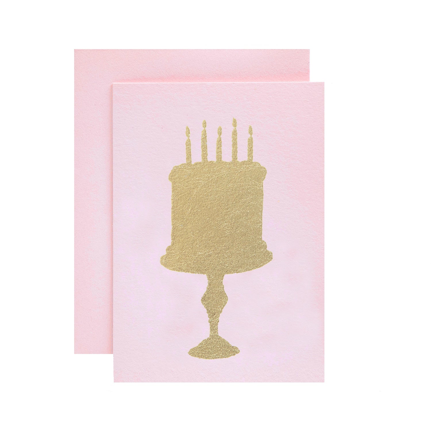 A light pink card with the silhouette of a birthday cake on a stand in solid gold leaf.