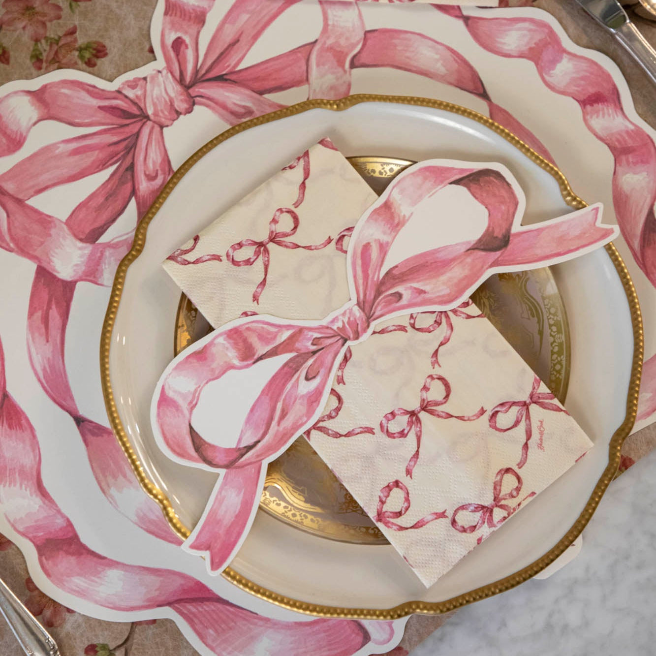 An elegant place setting with the Pink Bow Table Accent on the Pink Bow Guest Napkin, centered on the plates.