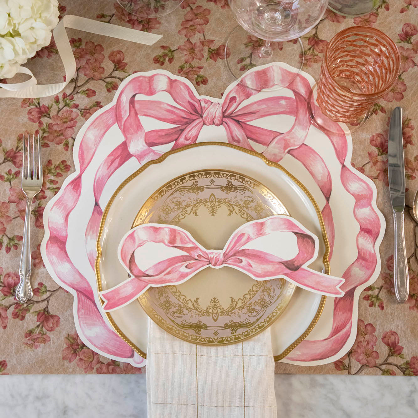 An elegant place setting with the Die-cut Pink Bow Placemat on the Pink Cherry Blossom Runner.