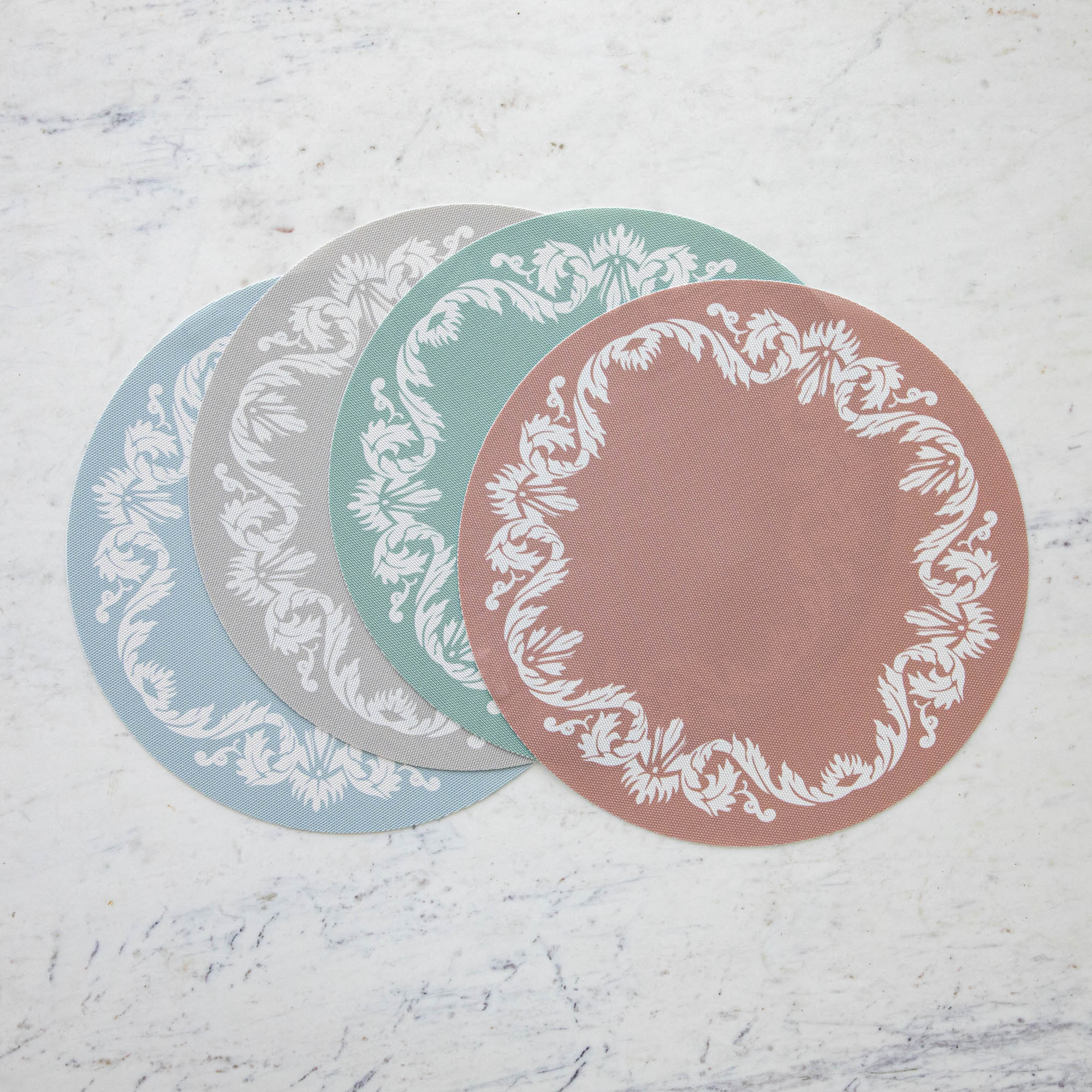 Scroll Round Placemat in four colors fanned out