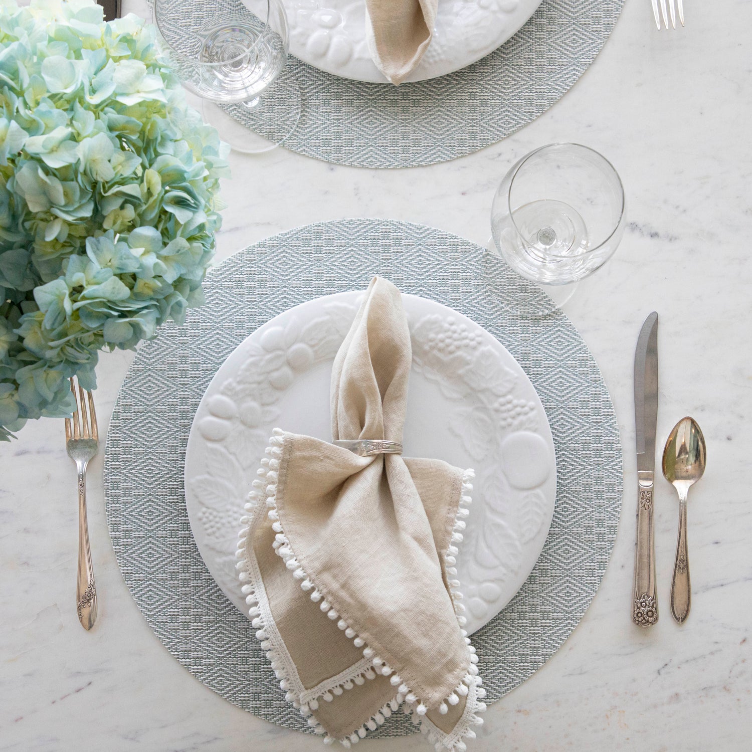 Boxwood Round Placemat with place setting on it