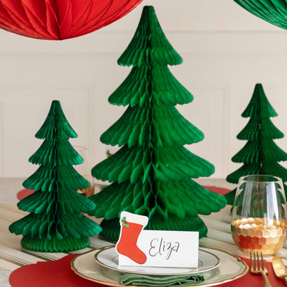 A festive Christmas table setting with the Honeycomb Extra Large Tree behind a place setting and next to smaller honeycomb trees.