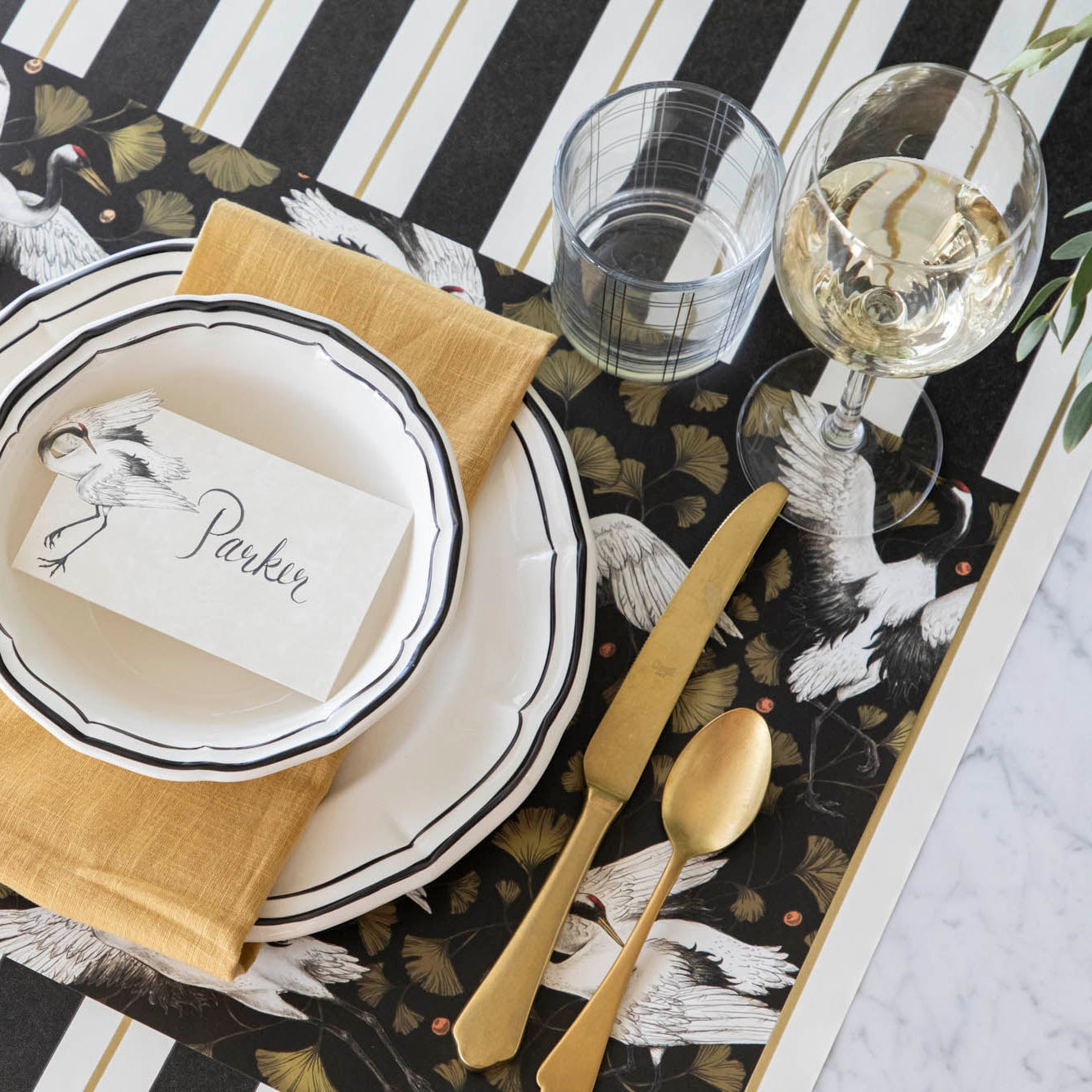 Crane Dance Placemat under an elegantly styled place setting for one.