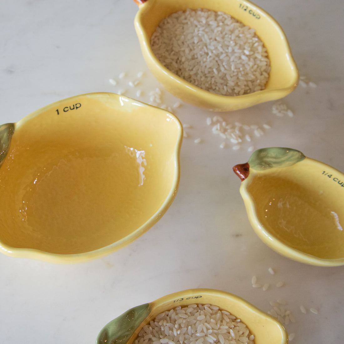 A top down view of the Stoneware Lemon Measuring Cups, Set of 4 showing the depth.