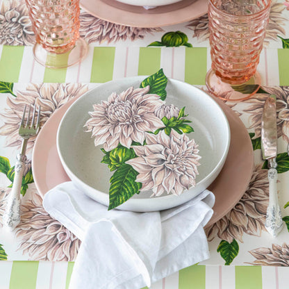 Dahlia Table Accent resting in the center of dinner plates on a place setting.