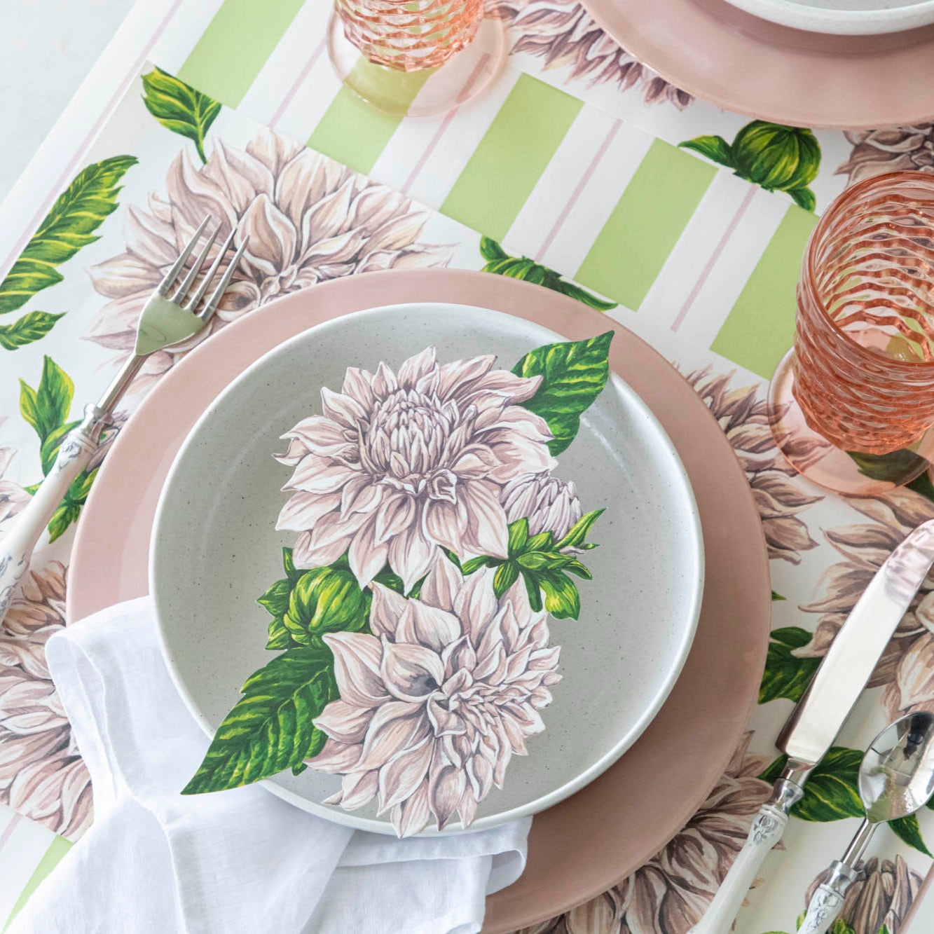 Dahlia Table Accent resting on a bowl, on a place setting for one.