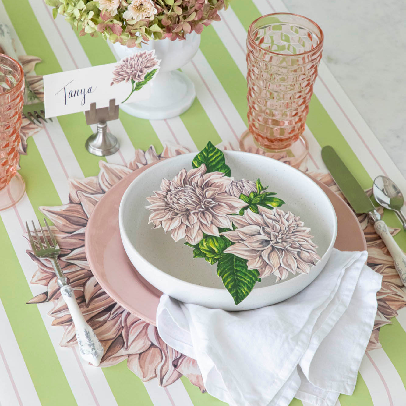 A floral table setting with the Die-cut Dahlia Placemat on the Green &amp; Pink Awning Stripe Runner.