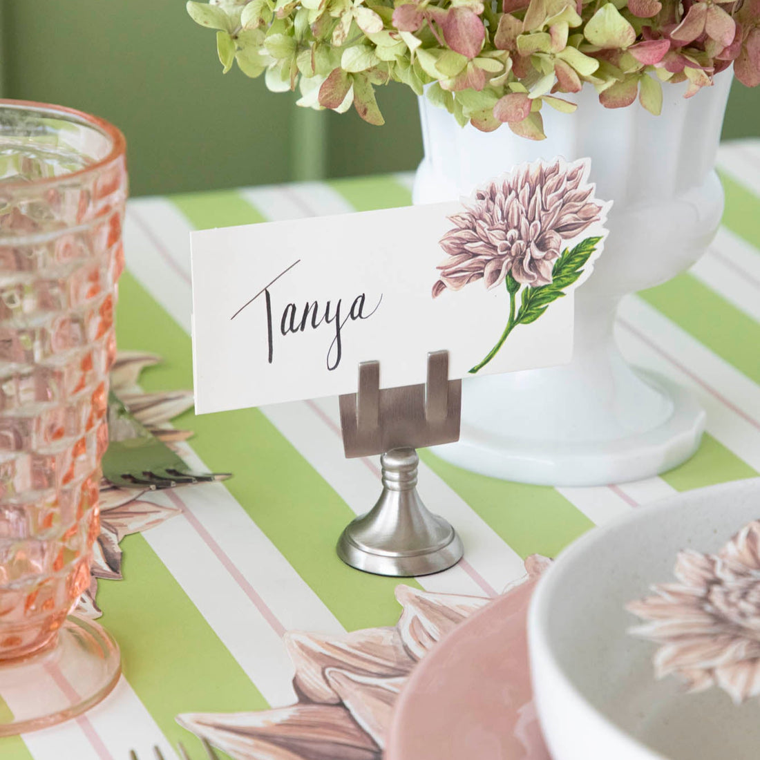 Dahlia Place Card with &quot;Tanya&quot; written in the white space, held up by the Chrome Place Card Holder.